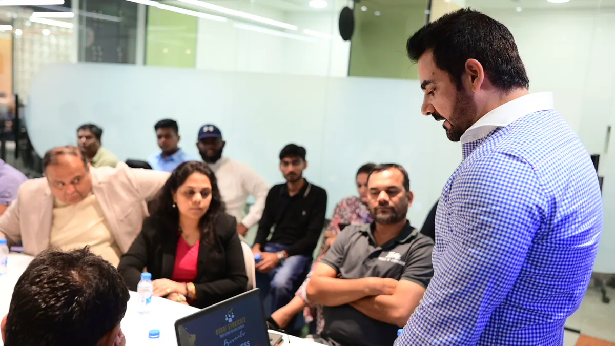 A founder presenting practical business insight to a focused room